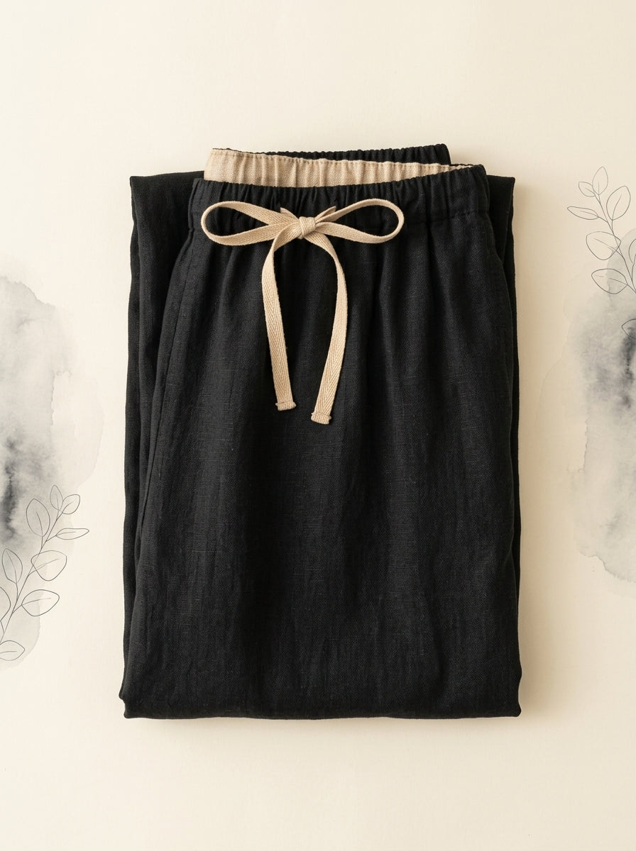 Cotton-Linen Drawstring Pants with Pockets in Black, folded flat