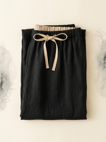 Cotton-Linen Drawstring Pants with Pockets in Black, folded flat
