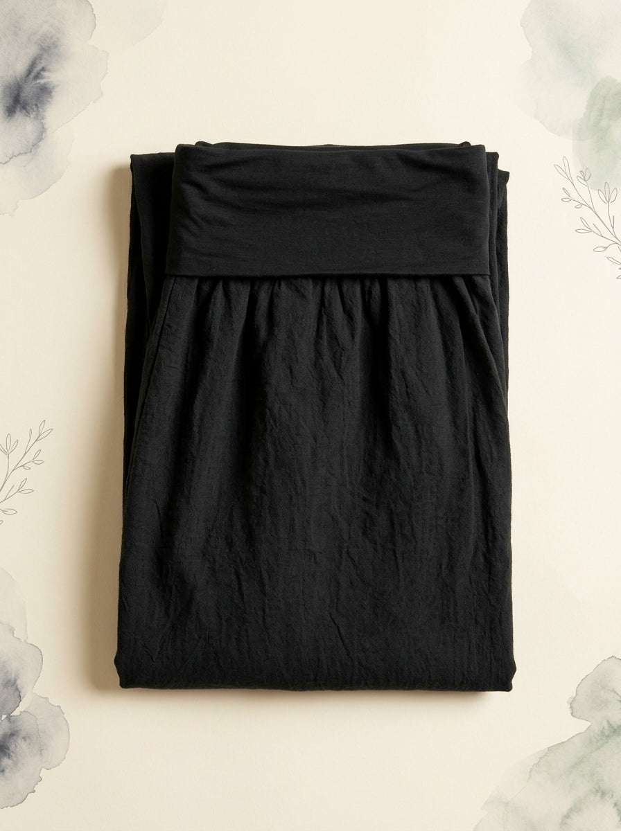 Plain Black Cotton Harem Pants in Black, folded flat